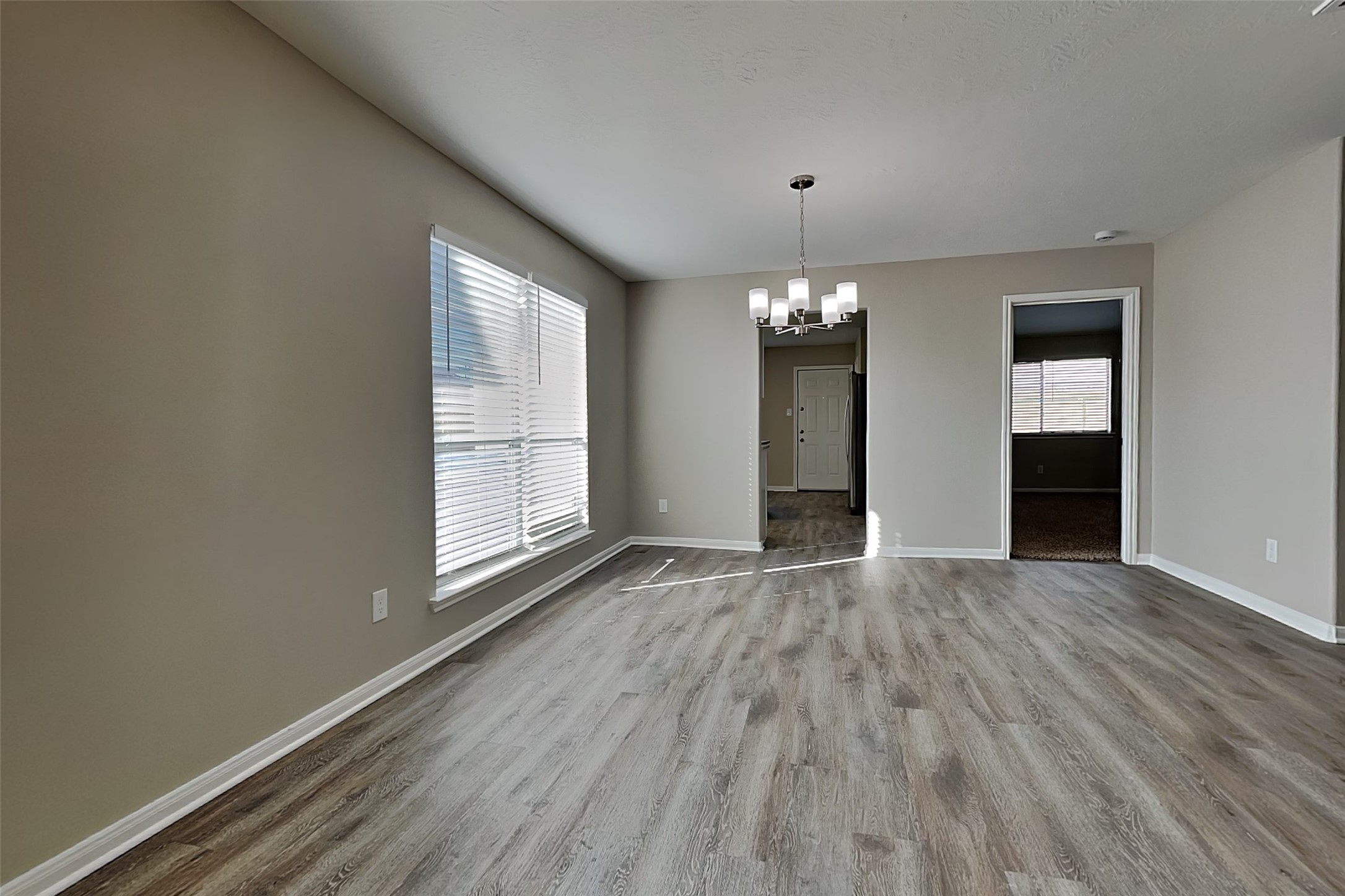29207 Fox Fountain Lane Spring, TX 77386 - Photo 11 of 24 an empty room with wooden floor and windows