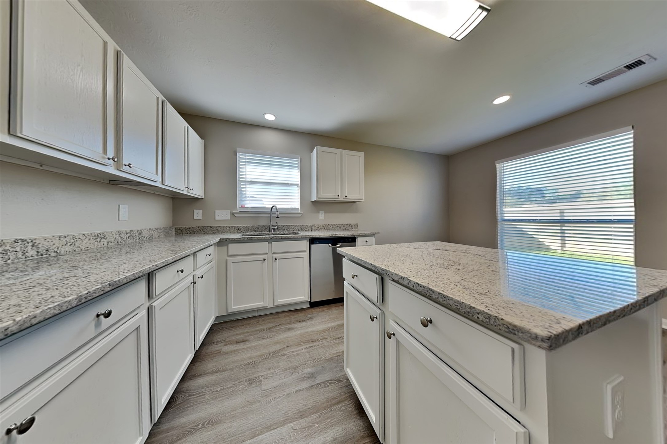 29207 Fox Fountain Lane Spring, TX 77386 - Photo 7 of 24 a kitchen with granite countertop white cabinets and white appliances