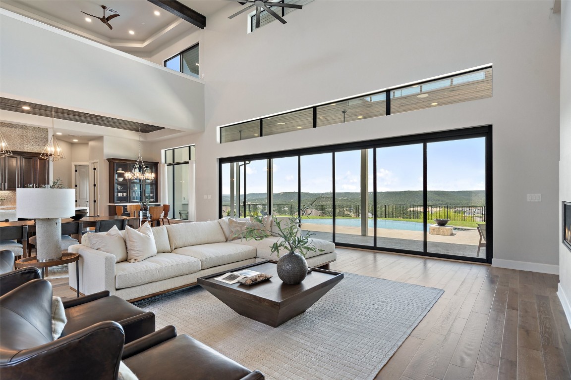 a living room with furniture and a large window with balcony view
