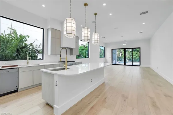 a view of a kitchen with a sink and window
