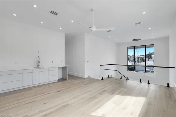 a view of a kitchen with sink and cabinet with wooden floor