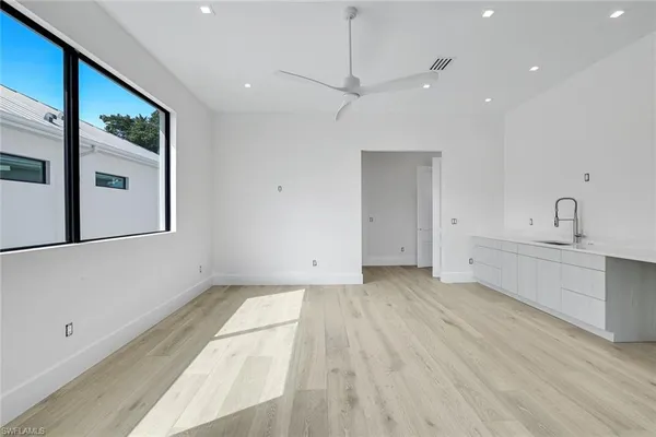 a view of a kitchen with furniture and wooden floor