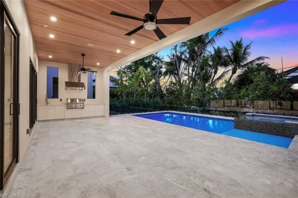 a view of swimming pool with outdoor seating and plants