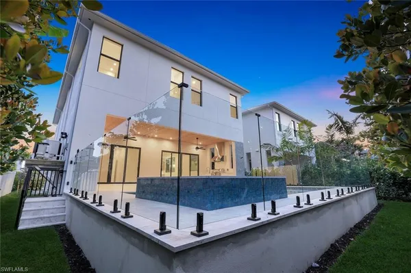 an aerial view of a house with swimming pool and porch with furniture