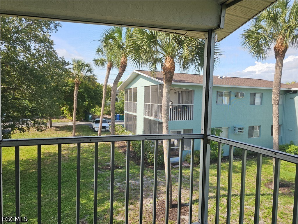 8101 Country Road, Unit 201 Fort Myers, FL 33919 - Photo 19 of 34 a view of a house with a large window and wooden fence