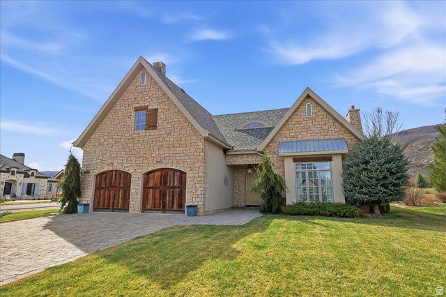 930 Price Farm Court Midway, UT 84049 - Photo 6 of 42 View of front facade featuring a front yard, a chimney, decorative driveway, and stone siding