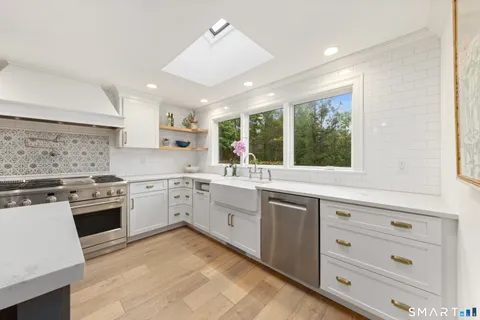 a kitchen with stove a sink and cabinets