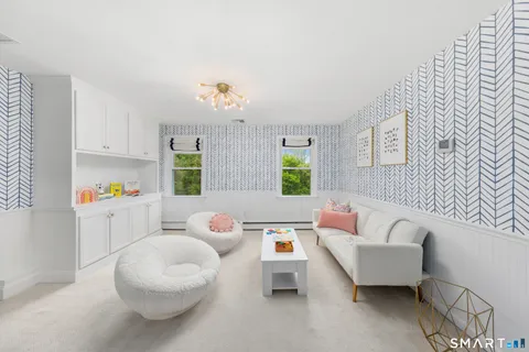 a bedroom with a bed and painting on the wall