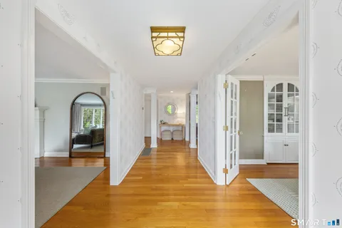 a living room with furniture fireplace and large windows