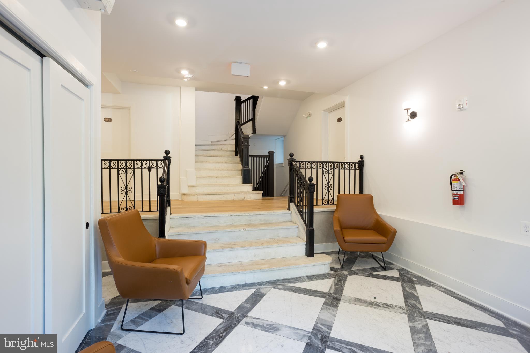 2869 28th Street Northwest, Unit 1 Washington, DC 20008 - Photo 1 of 19 a hallway with chairs and a dining table with wooden floor