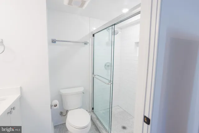 a bathroom with a toilet a sink and shower