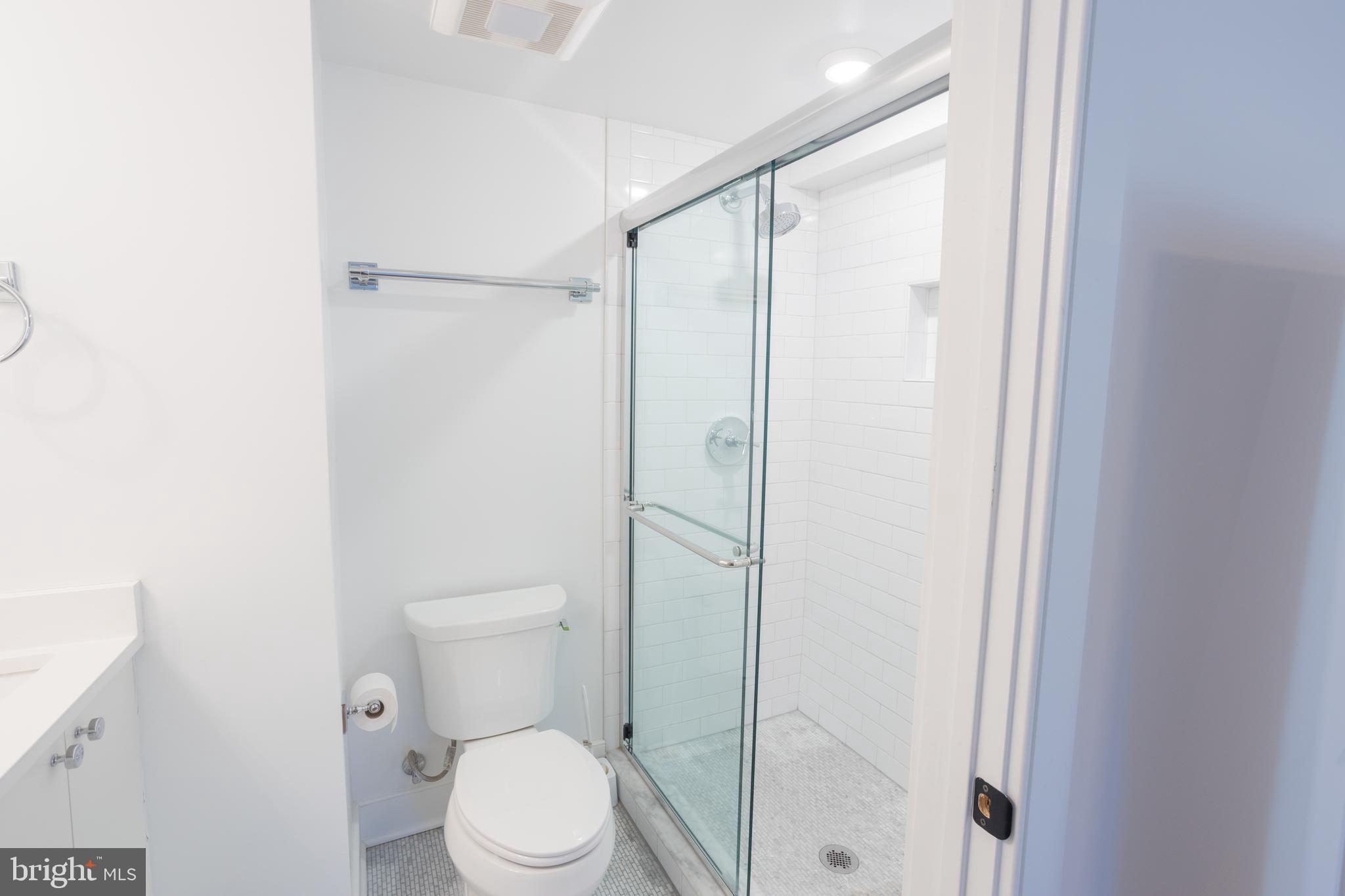 2869 28th Street Northwest, Unit 1 Washington, DC 20008 - Photo 15 of 19 a bathroom with a toilet a sink and shower