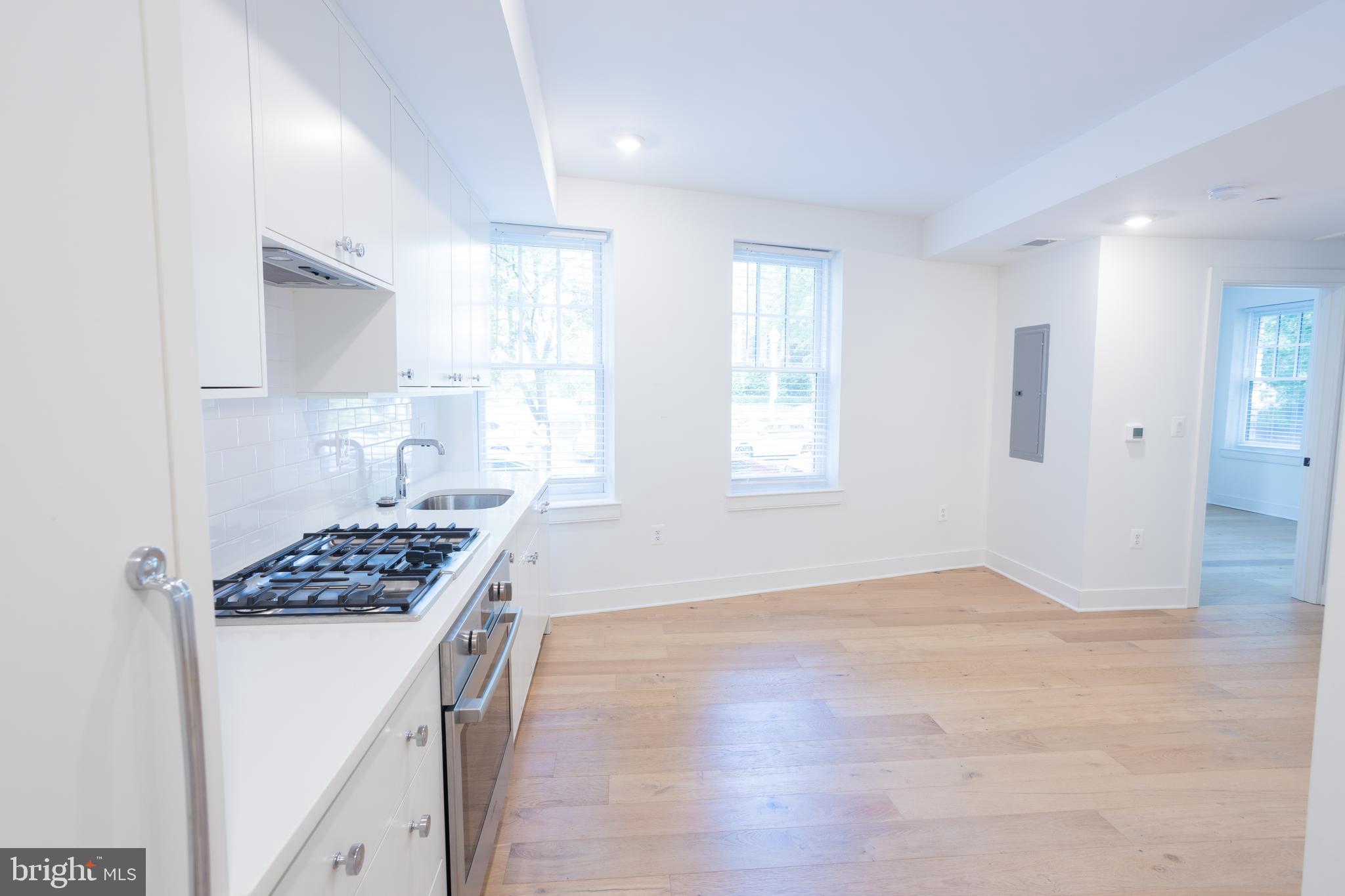 2869 28th Street Northwest, Unit 1 Washington, DC 20008 - Photo 17 of 19 a view of kitchen and sink with wooden floor