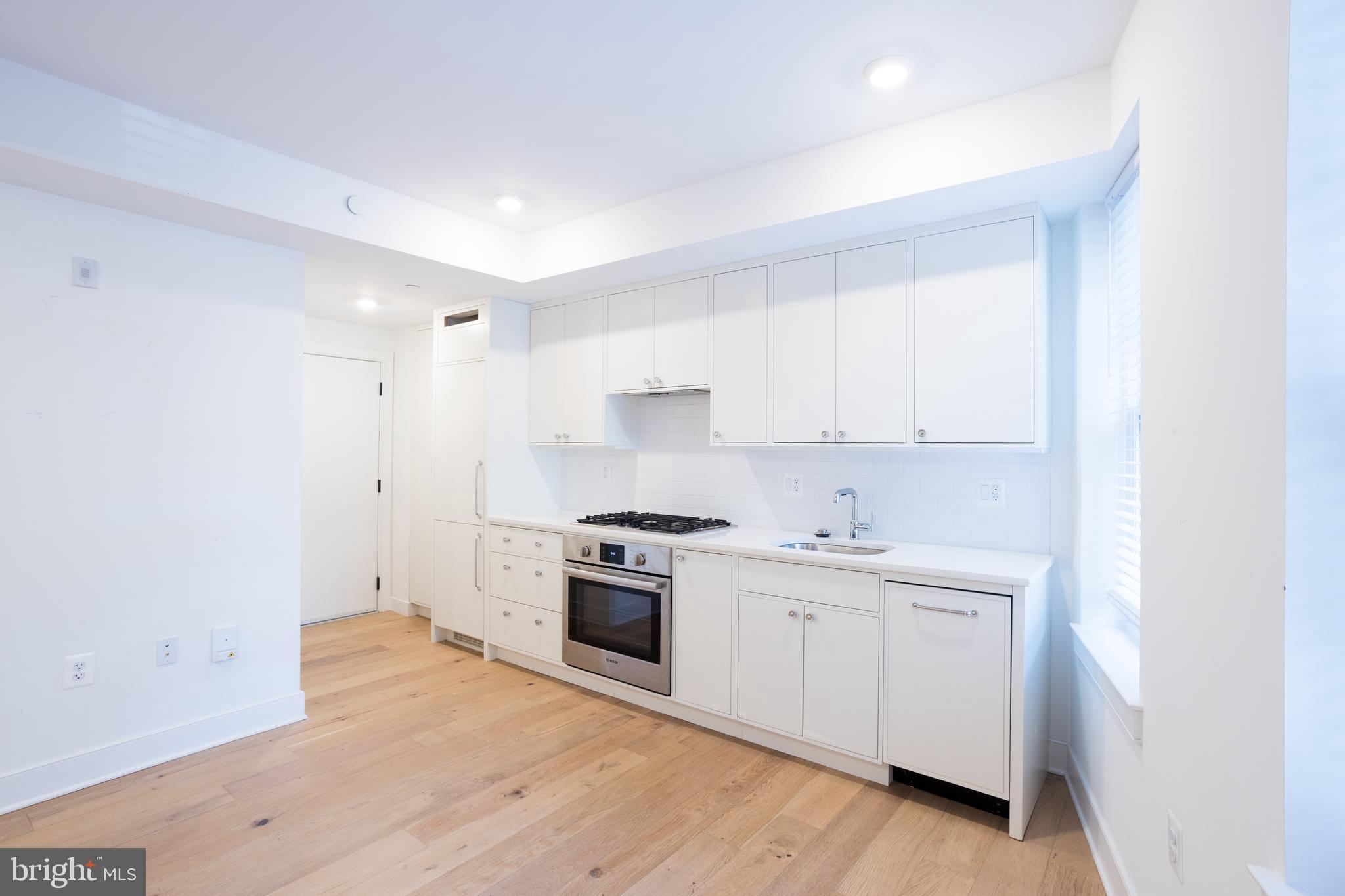 2869 28th Street Northwest, Unit 1 Washington, DC 20008 - Photo 19 of 19 a kitchen with a stove top oven and sink