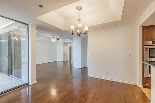 a view of a kitchen with a sink and dishwasher a refrigerator with wooden floor