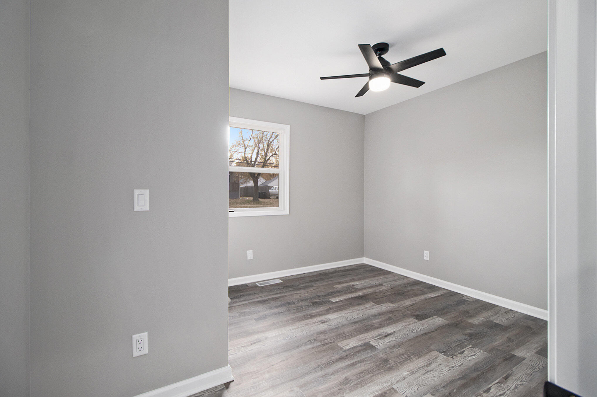 4124 Liverpool Road Lake Station, IN 46405 - Photo 11 of 18 a view of empty room with wooden floor and window