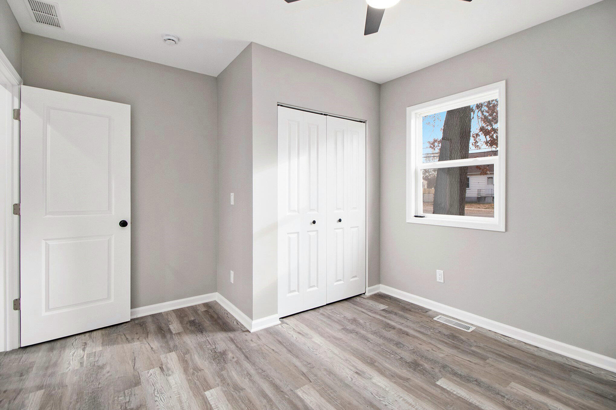 4124 Liverpool Road Lake Station, IN 46405 - Photo 12 of 18 a view of an empty room with wooden floor and a window
