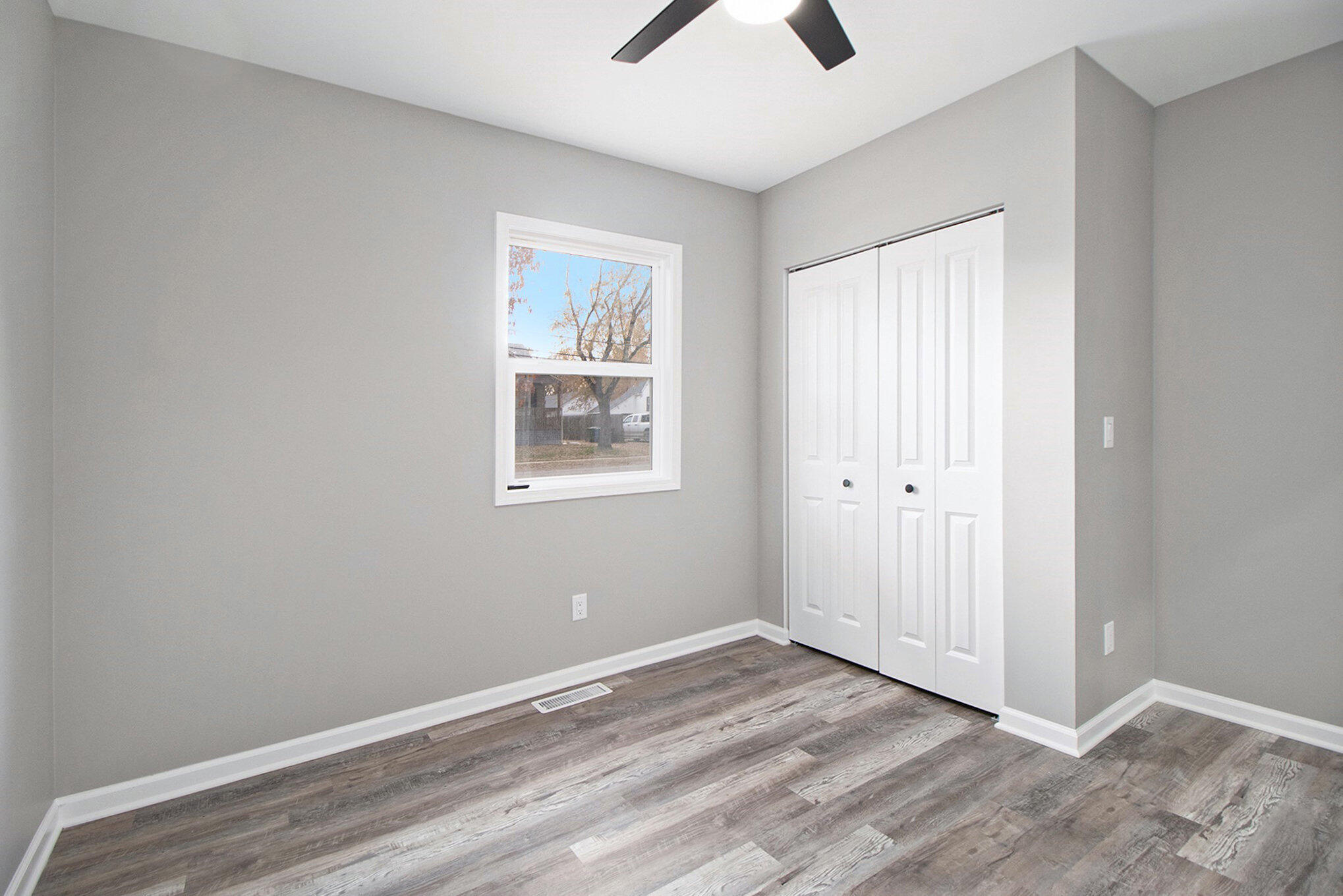 4124 Liverpool Road Lake Station, IN 46405 - Photo 13 of 18 a view of an empty room with wooden floor and a window