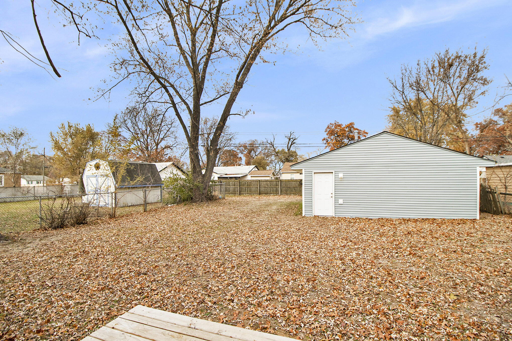 4124 Liverpool Road Lake Station, IN 46405 - Photo 17 of 18 a backyard of a house with large trees