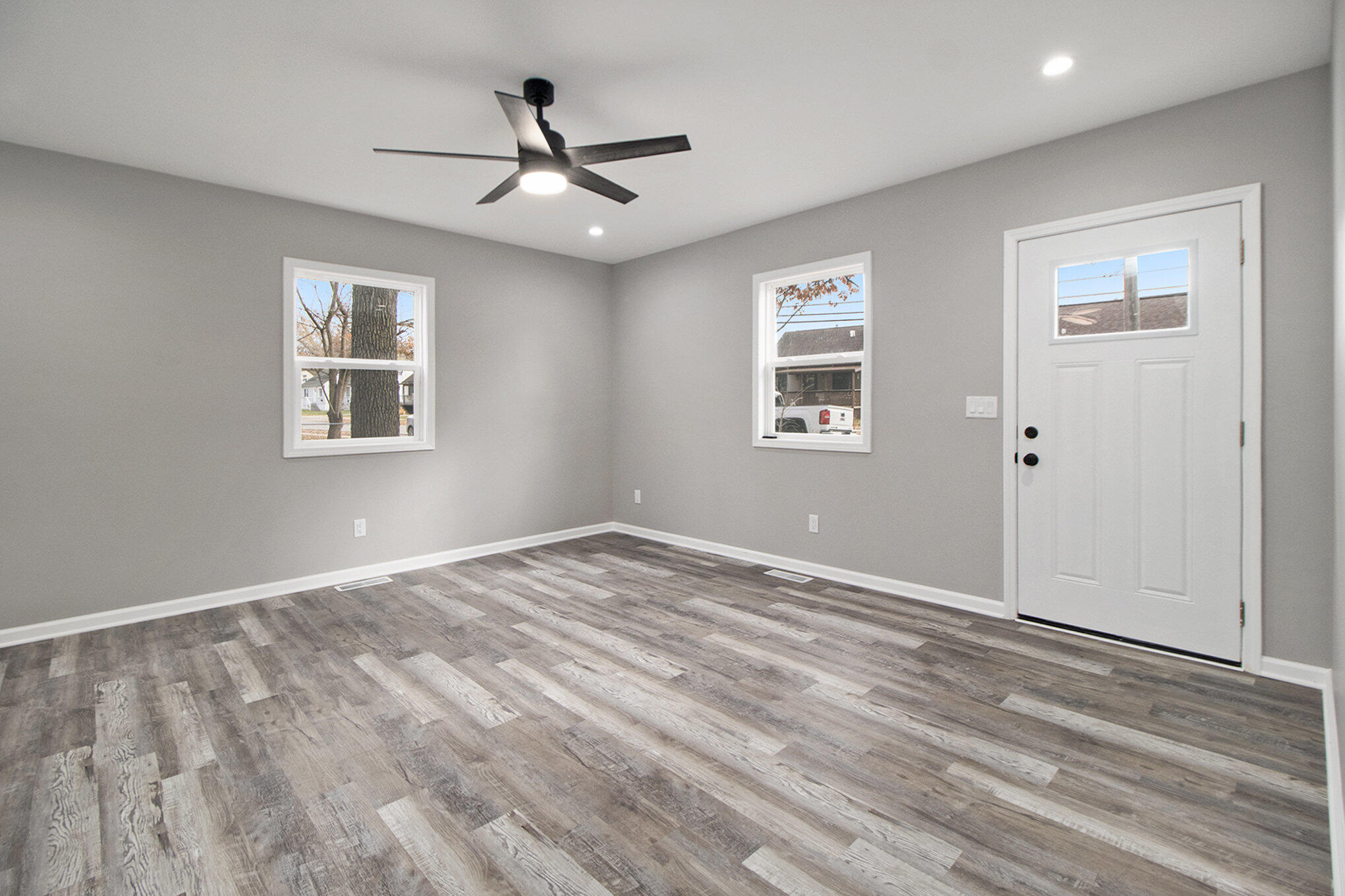 4124 Liverpool Road Lake Station, IN 46405 - Photo 4 of 18 a view of empty room with wooden floor and ceiling fan