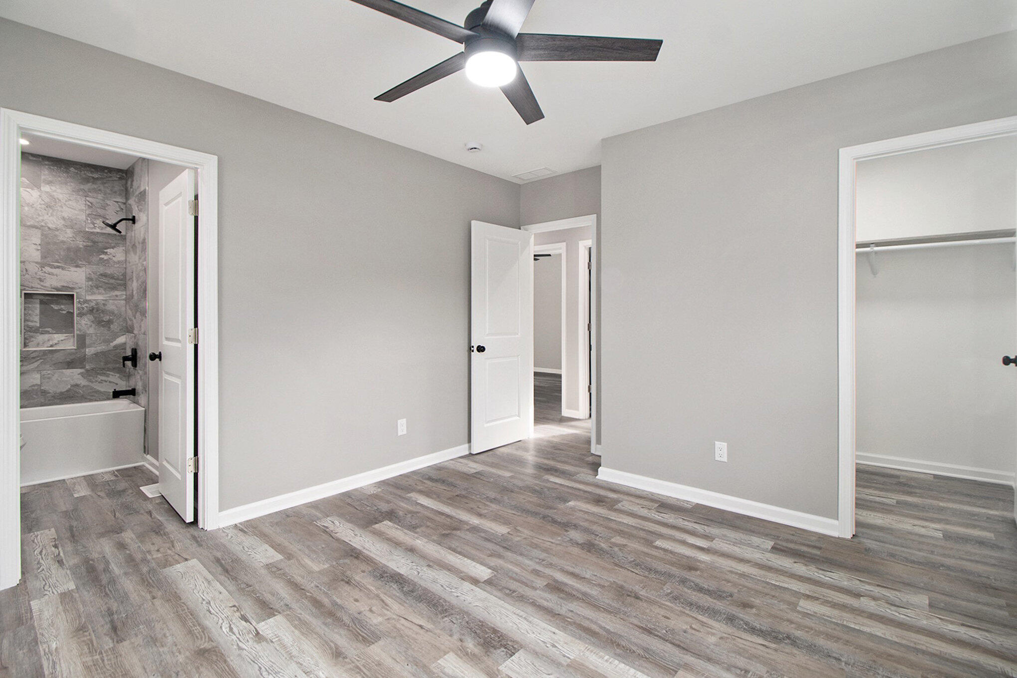 4124 Liverpool Road Lake Station, IN 46405 - Photo 9 of 18 a view of a room with wooden floor and a ceiling fan