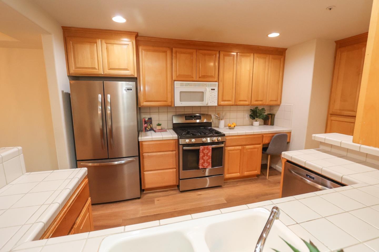 3372 Aptos Rancho Road Aptos, CA 95003 - Photo 12 of 40 a kitchen with a refrigerator sink and wooden cabinets