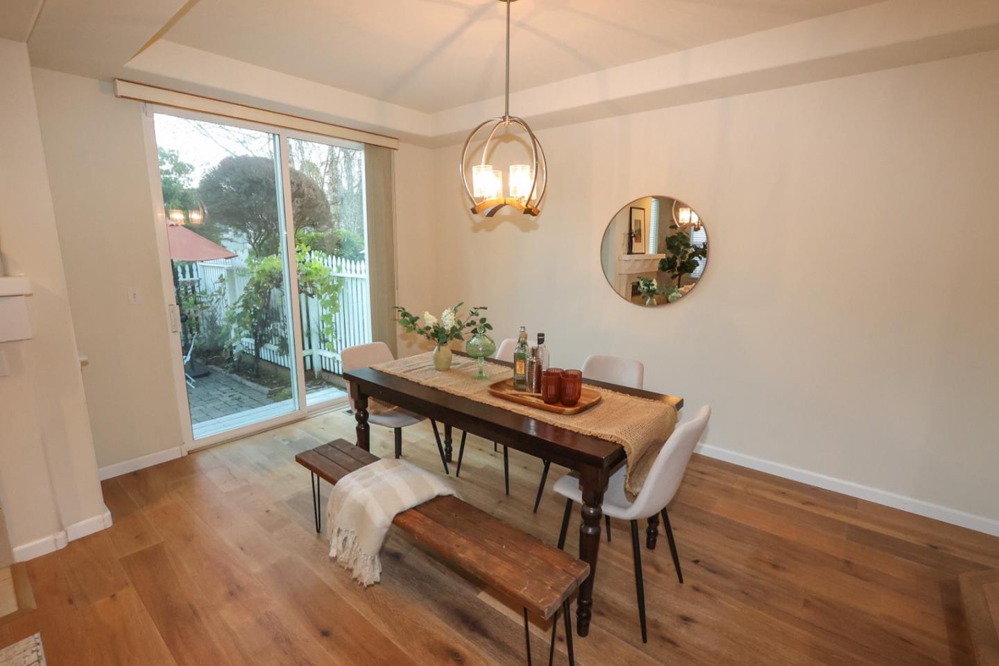 3372 Aptos Rancho Road Aptos, CA 95003 - Photo 15 of 40 a view of a dining room with furniture wooden floor and a chandelier