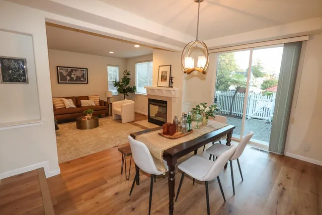 a view of a patio with a table and chairs under an umbrella