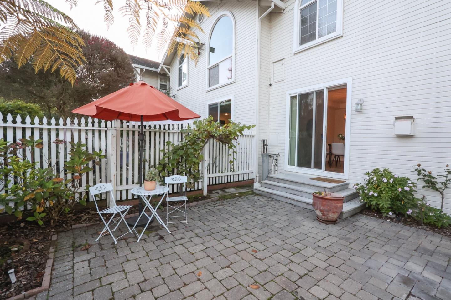 3372 Aptos Rancho Road Aptos, CA 95003 - Photo 17 of 40 a view of a patio with a table and chairs under an umbrella