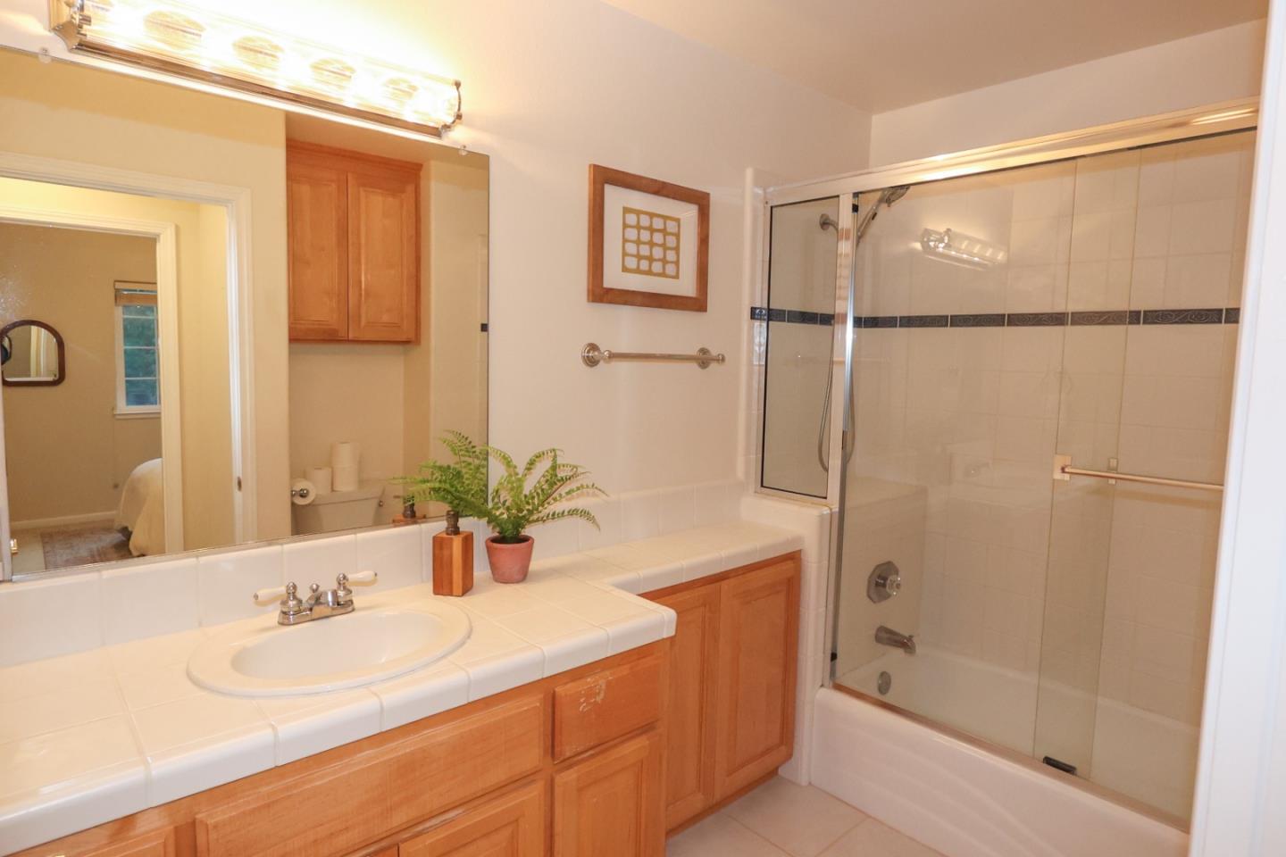 3372 Aptos Rancho Road Aptos, CA 95003 - Photo 20 of 40 a bathroom with a double vanity sink and a mirror