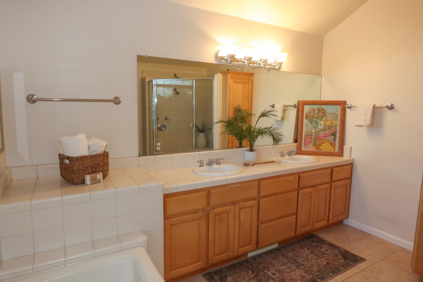 3372 Aptos Rancho Road Aptos, CA 95003 - Photo 25 of 40 a bathroom with a sink a mirror and a shower
