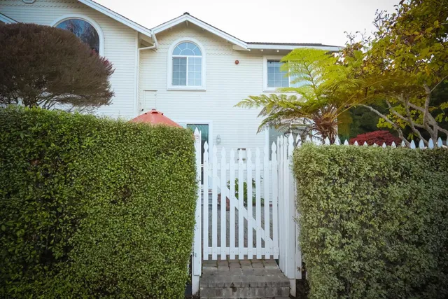 a backyard of a house with barbeque oven