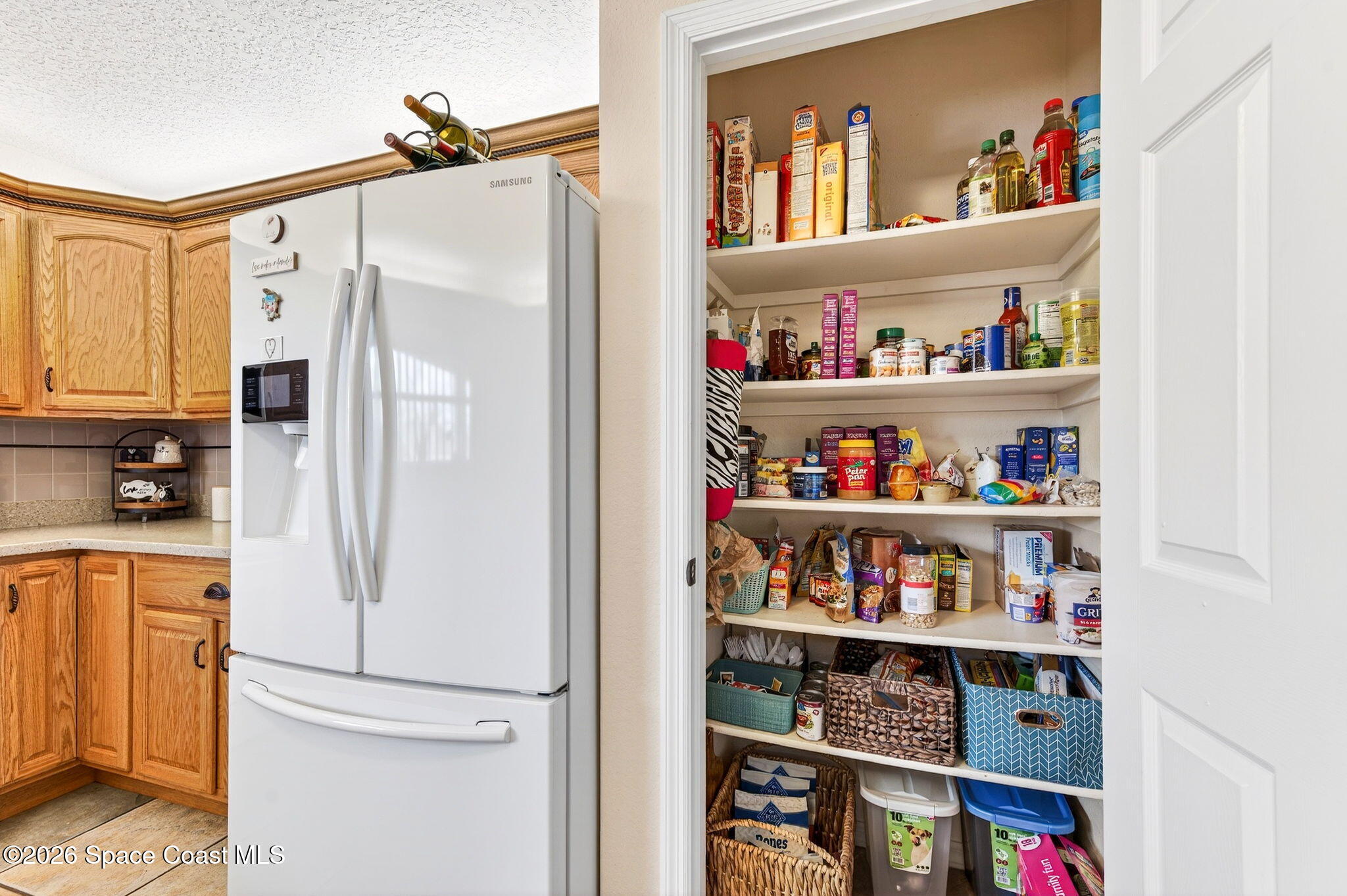 3969 Ridgewood Drive Titusville, FL 32796 - Photo 16 of 34 a white refrigerator freezer sitting in a kitchen