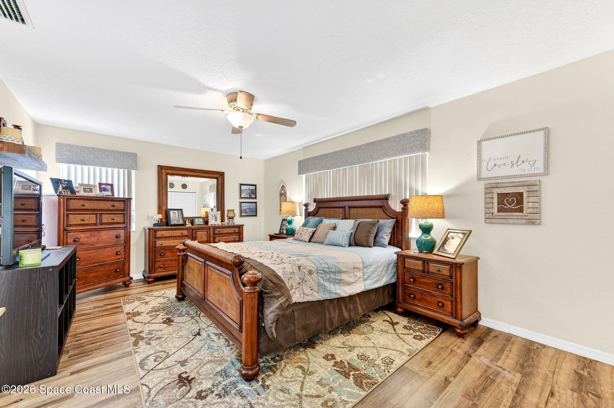 3969 Ridgewood Drive Titusville, FL 32796 - Photo 17 of 34 a bedroom with a bed and wooden floor