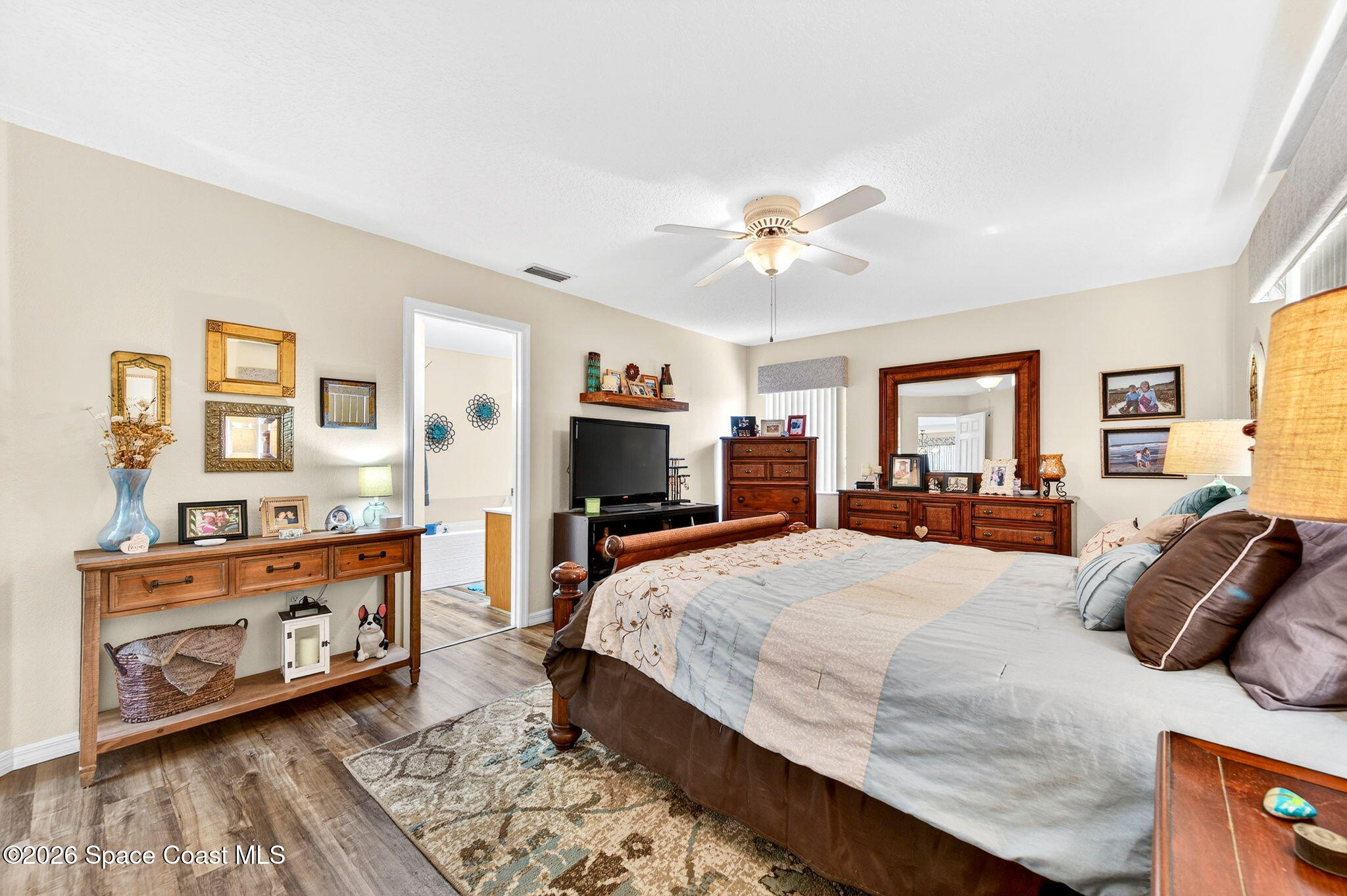 3969 Ridgewood Drive Titusville, FL 32796 - Photo 18 of 34 a bedroom with a bed and wooden floor