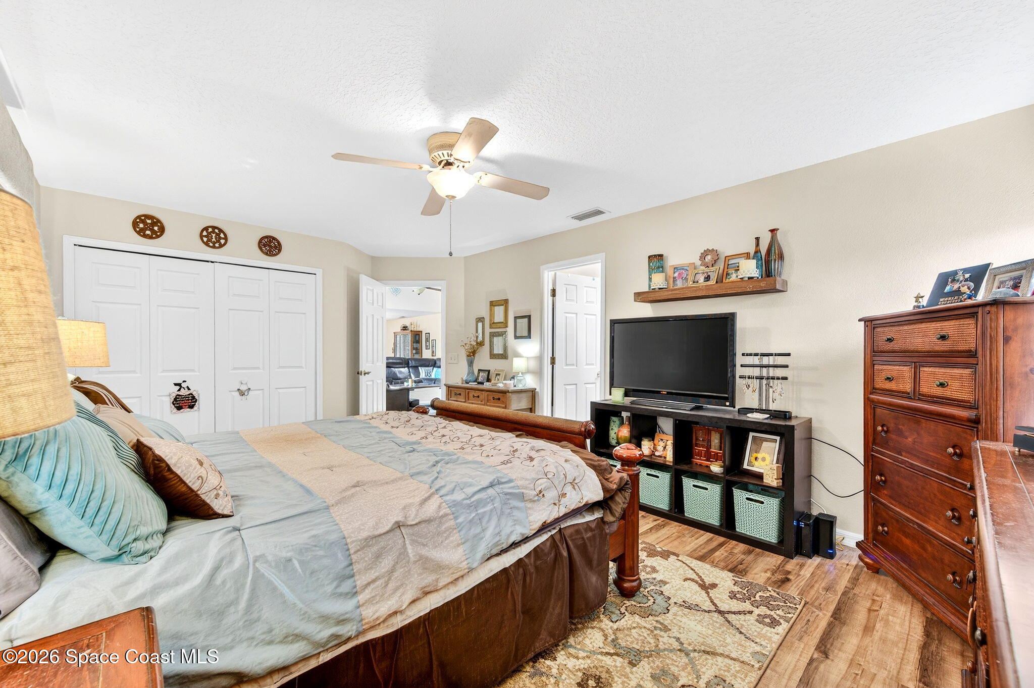 3969 Ridgewood Drive Titusville, FL 32796 - Photo 19 of 34 a bedroom with a bed and a flat screen tv