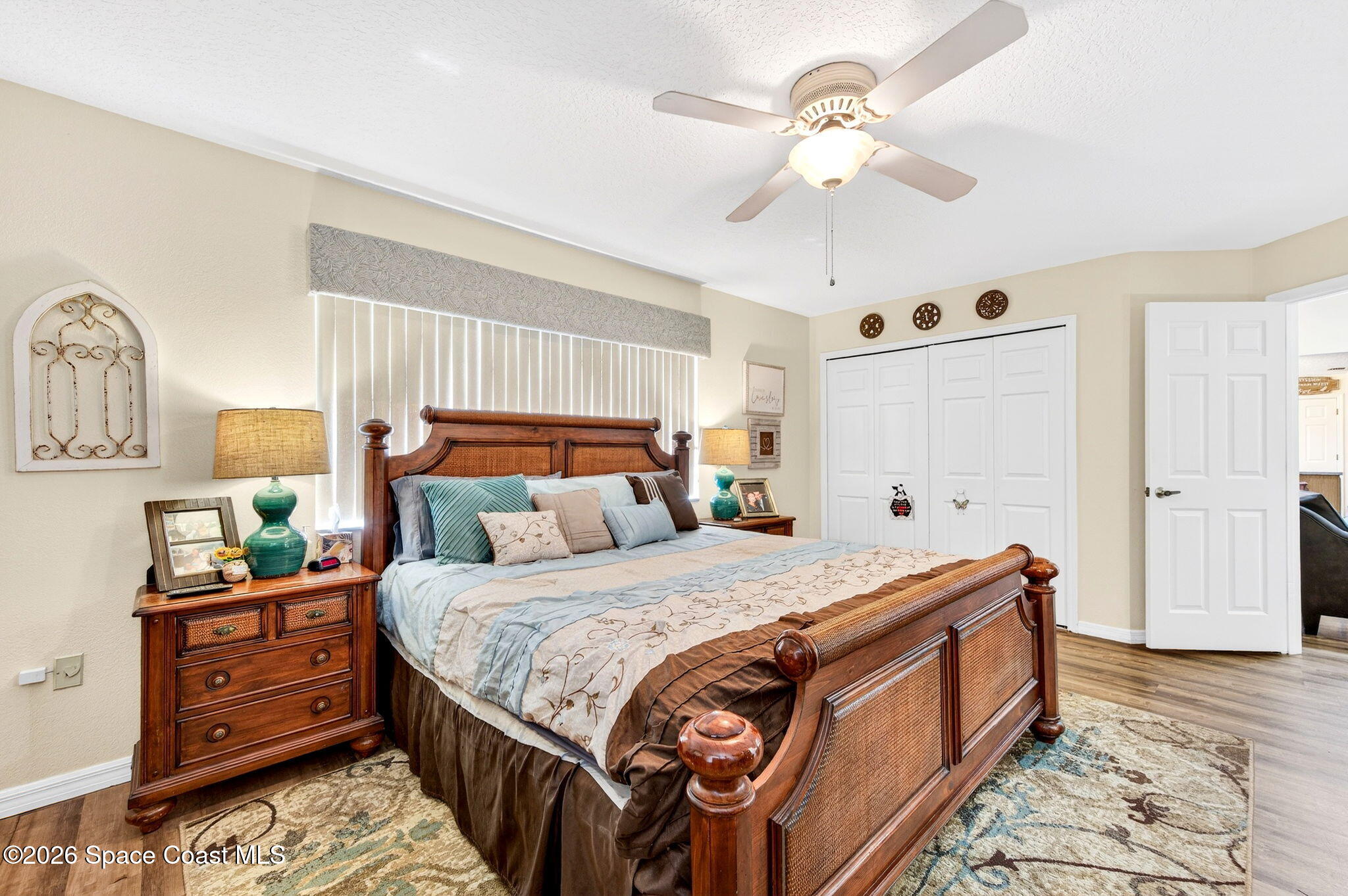 3969 Ridgewood Drive Titusville, FL 32796 - Photo 20 of 34 a bedroom with bed and a chandelier