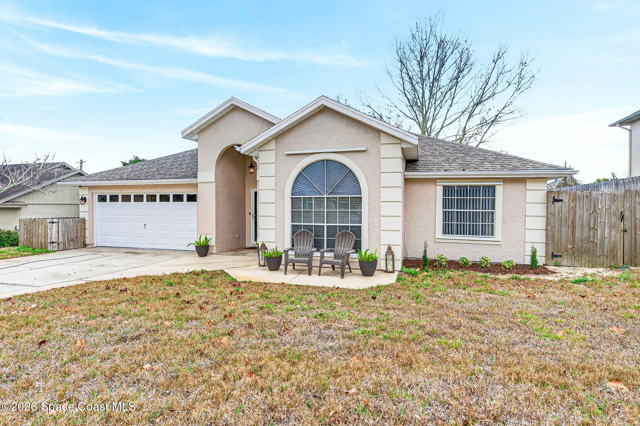 3969 Ridgewood Drive Titusville, FL 32796 - Photo 2 of 34 a front view of a house with a yard and garage