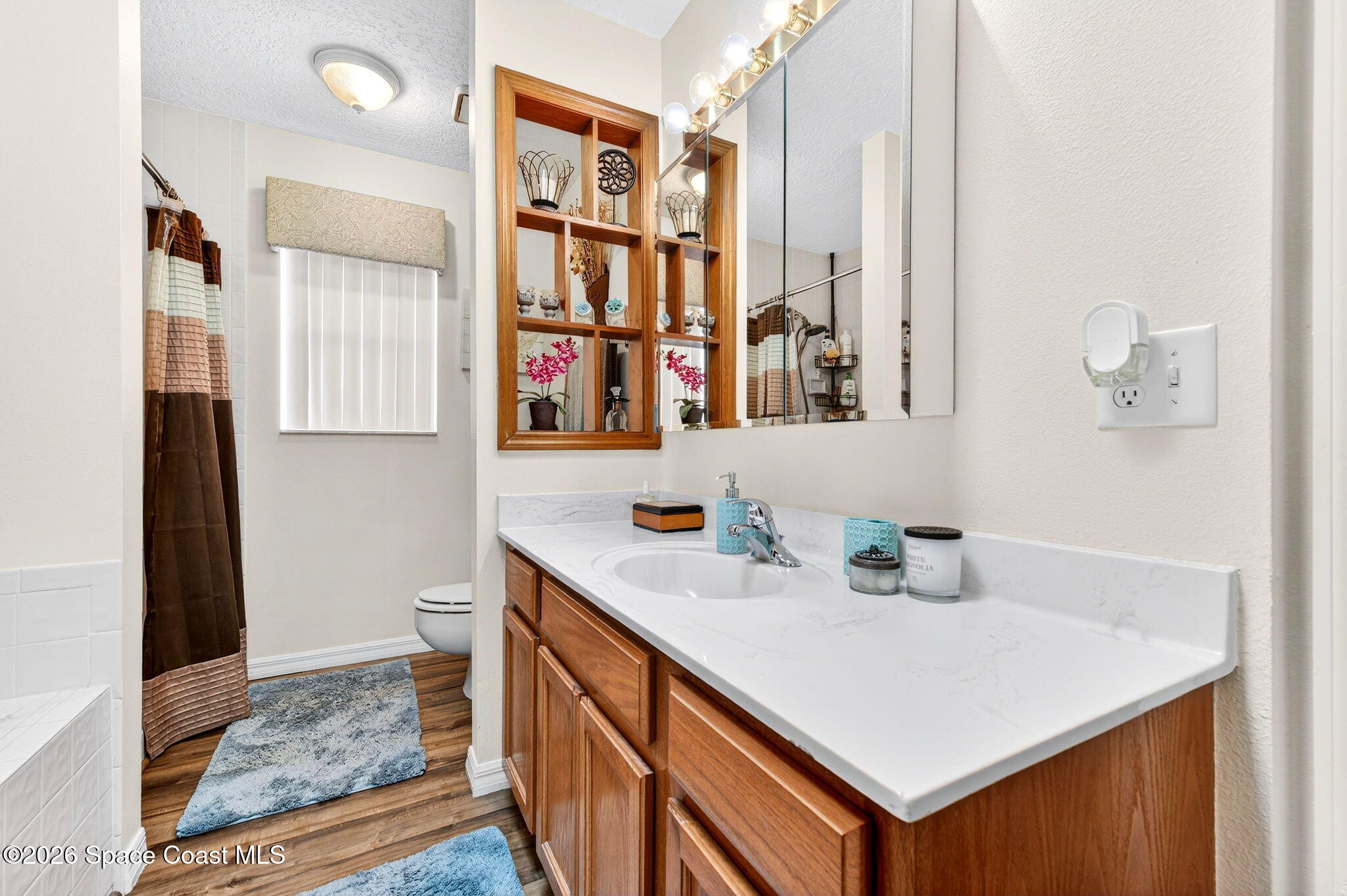 3969 Ridgewood Drive Titusville, FL 32796 - Photo 21 of 34 a bathroom with a sink double vanity and a shower