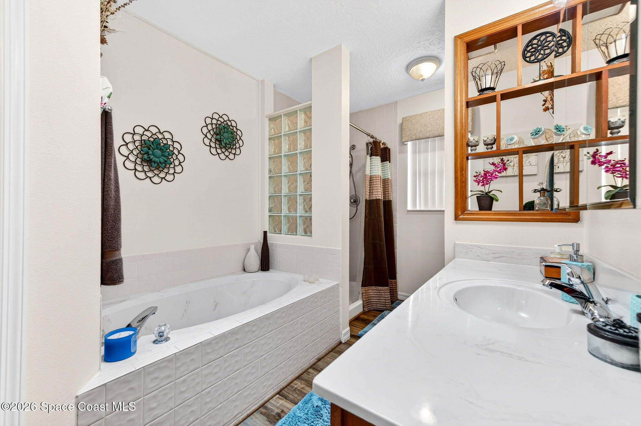 3969 Ridgewood Drive Titusville, FL 32796 - Photo 22 of 34 a bathroom with a tub sink and a window