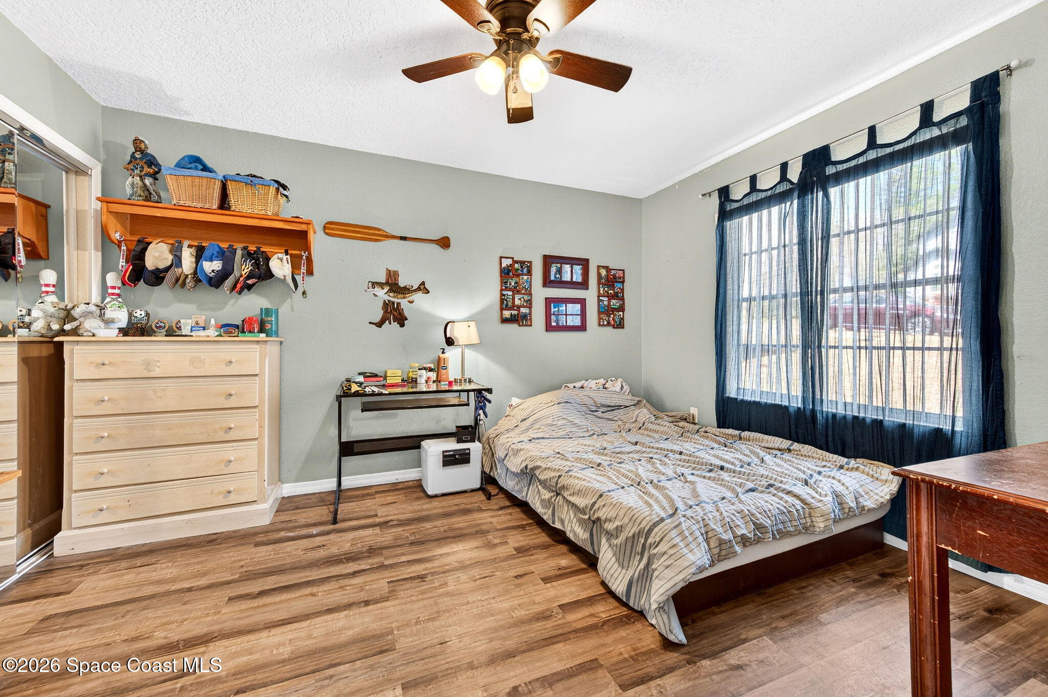 3969 Ridgewood Drive Titusville, FL 32796 - Photo 24 of 34 a bedroom with a bed and a dresser