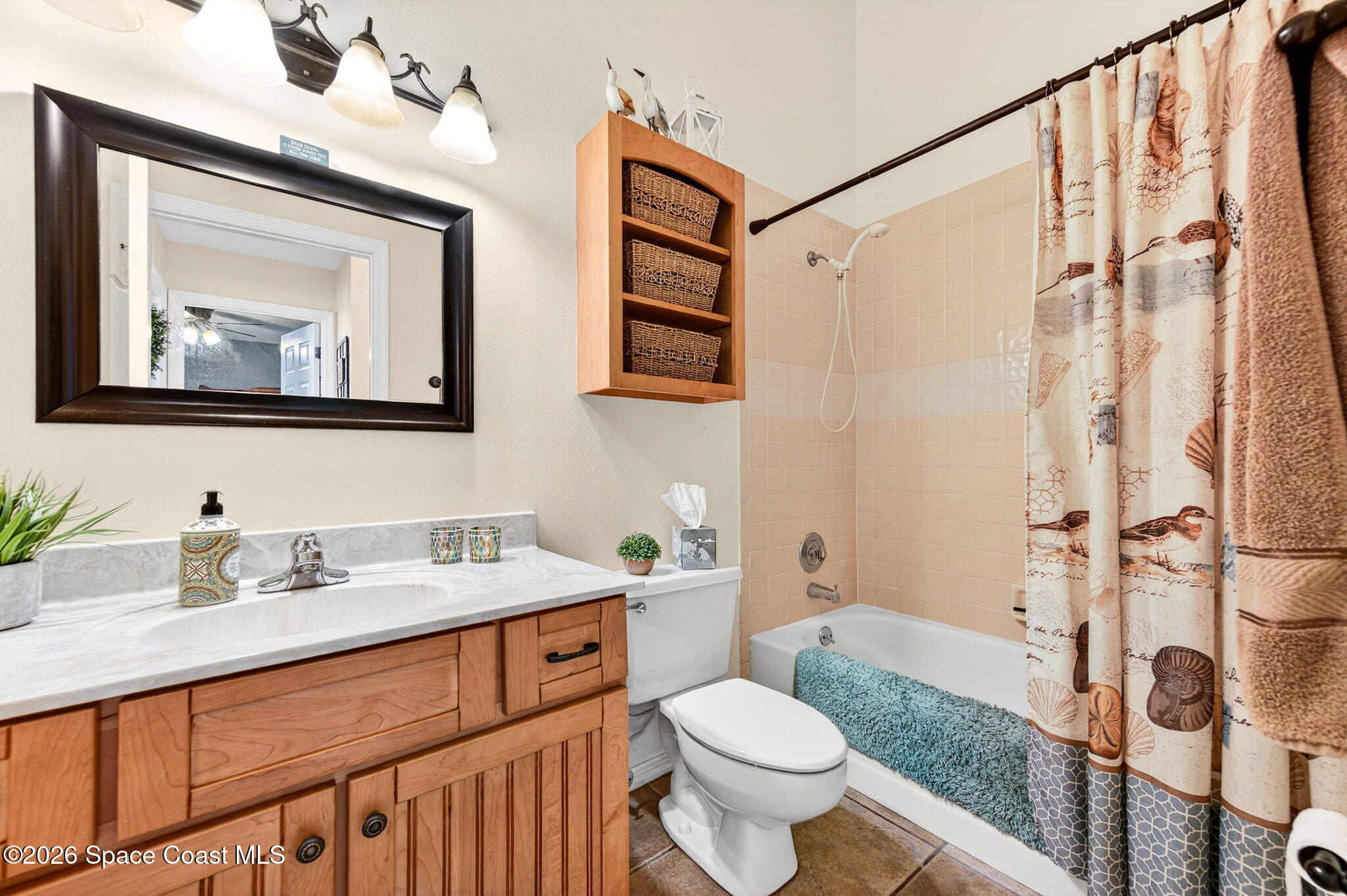 3969 Ridgewood Drive Titusville, FL 32796 - Photo 26 of 34 a bathroom with a granite countertop sink toilet and a mirror