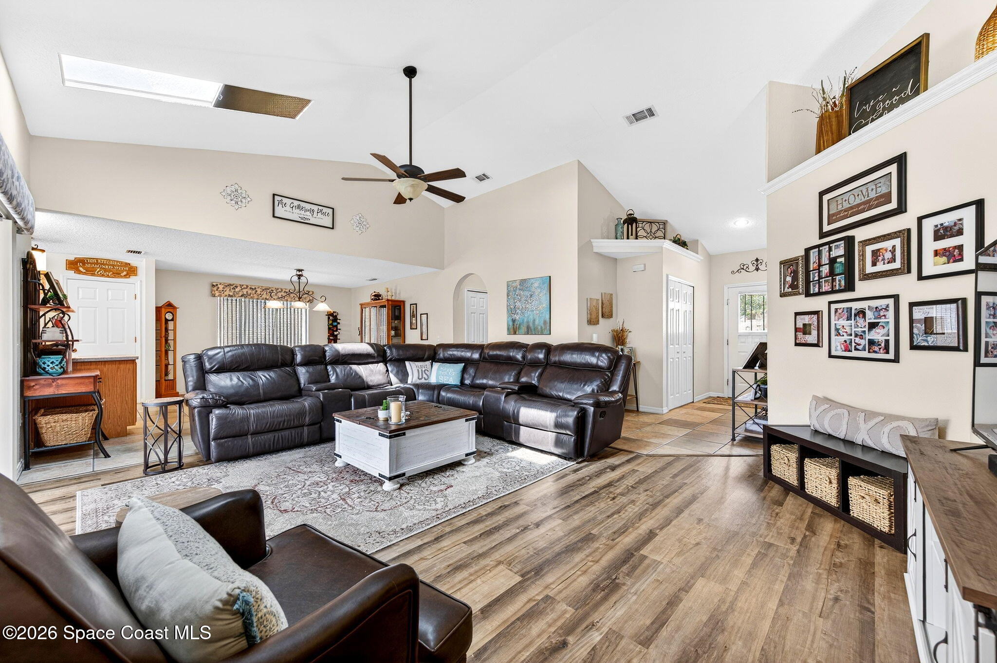 3969 Ridgewood Drive Titusville, FL 32796 - Photo 7 of 34 a living room with furniture kitchen view and a wooden floor