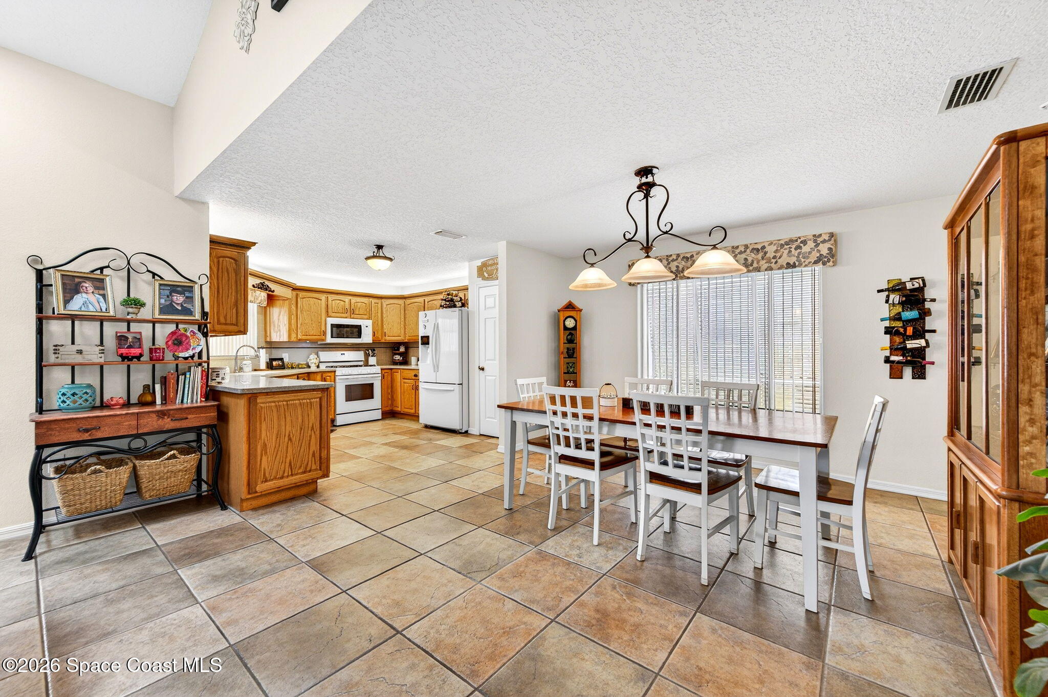 3969 Ridgewood Drive Titusville, FL 32796 - Photo 10 of 34 a dining hall with stainless steel appliances kitchen island granite countertop a table and chairs