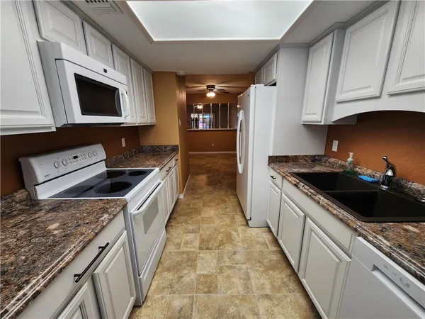 a kitchen with a sink and a stove top oven