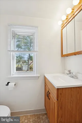 a bathroom with a sink a vanity and a window