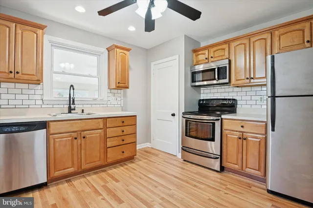 a kitchen with stainless steel appliances granite countertop a stove and a sink