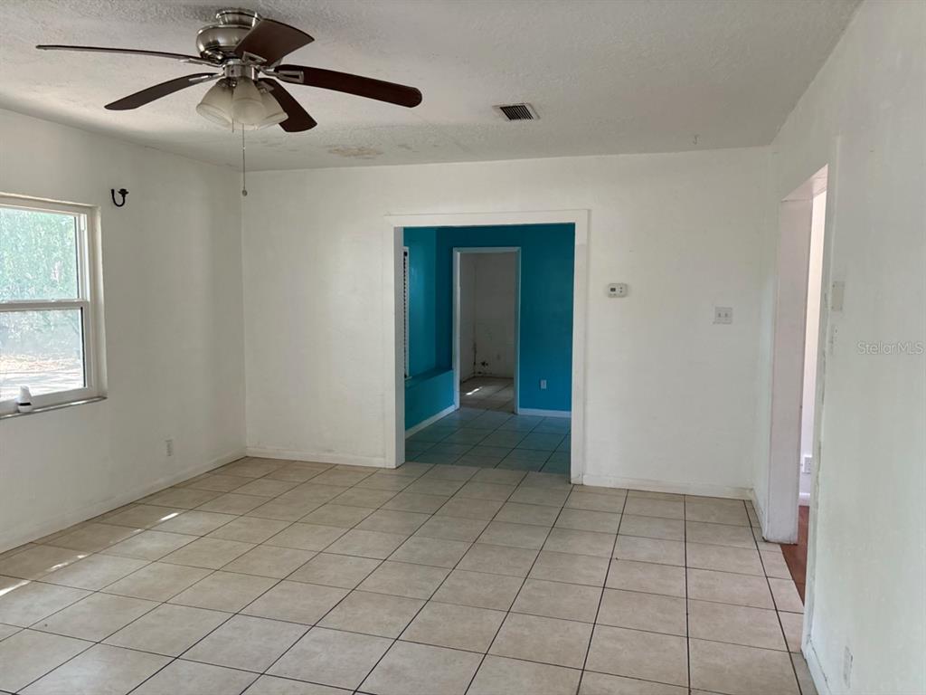 264 14th Street Northwest Largo, FL 33770 - Photo 3 of 12 a view of an empty room with window and chandelier fan