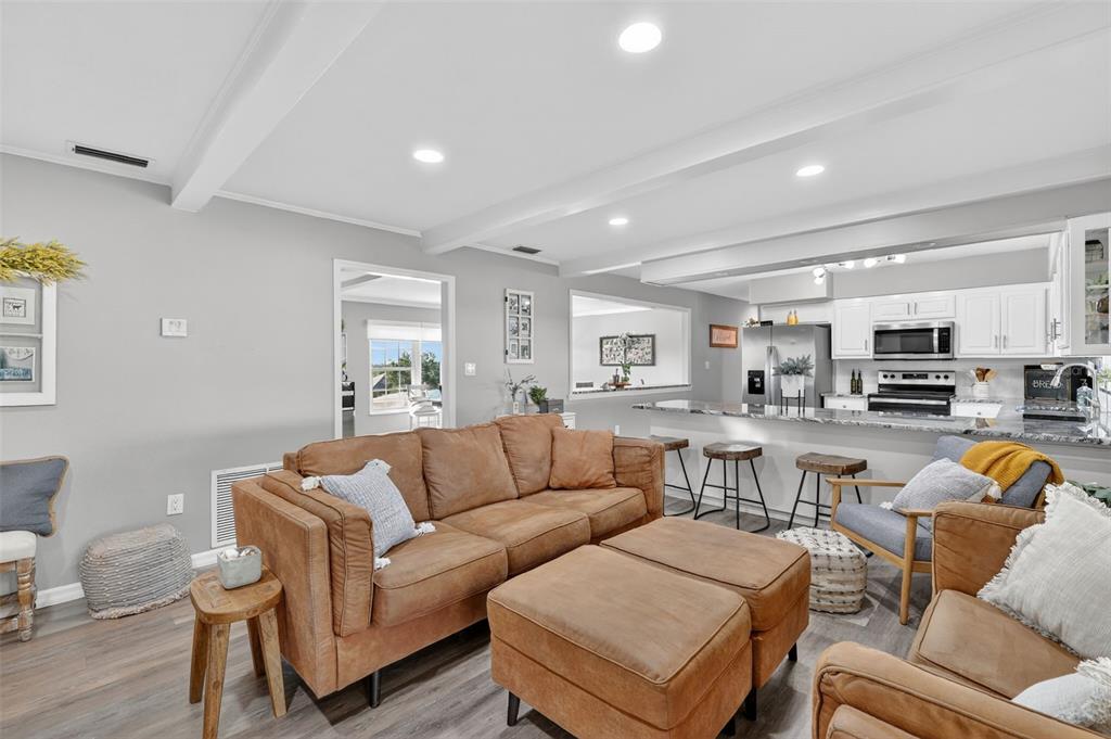 1101 Country Club Road Eustis, FL 32726 - Photo 12 of 44 a living room with furniture and kitchen view