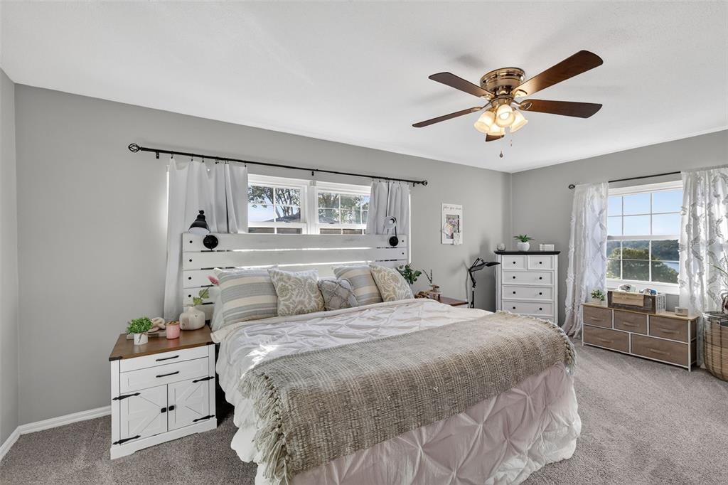 1101 Country Club Road Eustis, FL 32726 - Photo 19 of 44 a spacious bedroom with a bed and a window